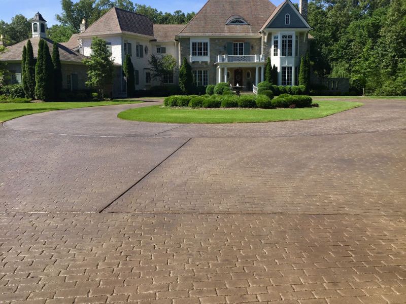 Exterior home in Collierville, TN showing a stamped concrete driveway installation.
