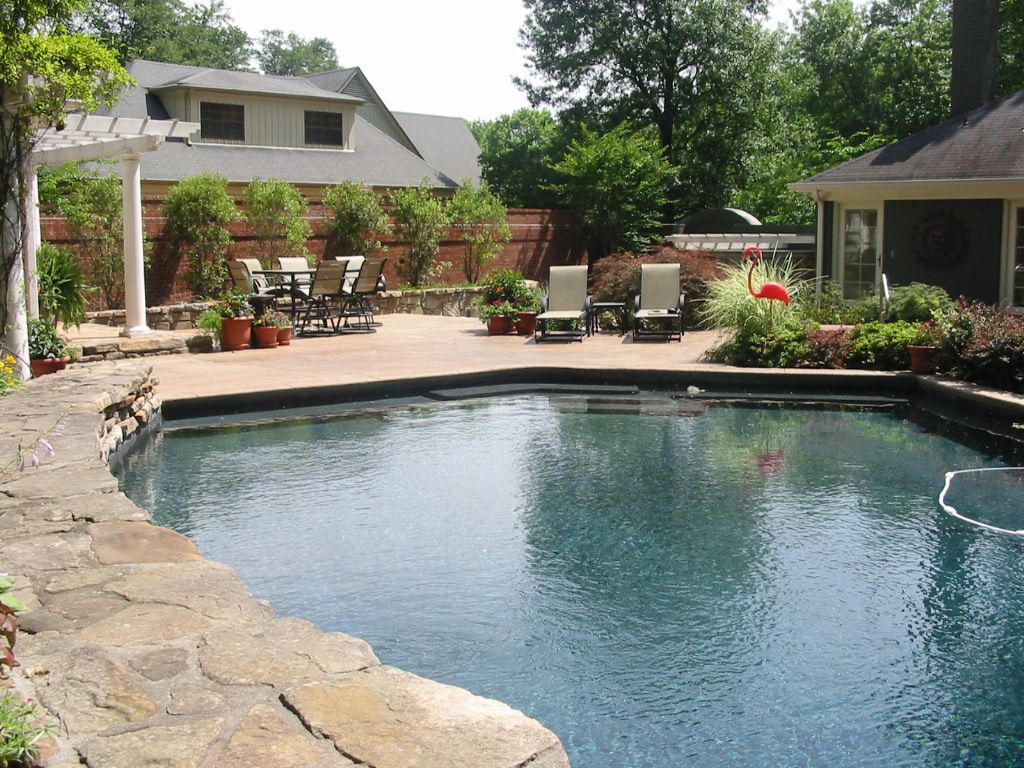 Large custom shape concrete pool deck.