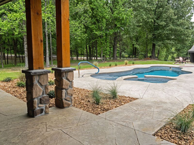 Landscape and covered porch with natural wood posts.