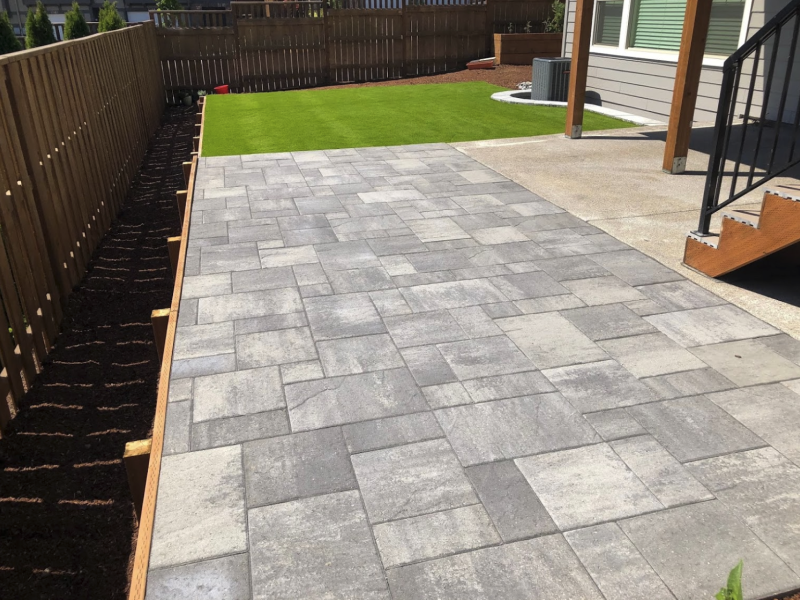 New patio installation with paver brick inlay.