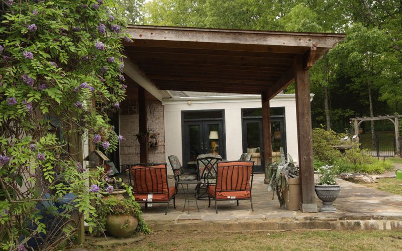 Extended outdoor patio with wood beams.